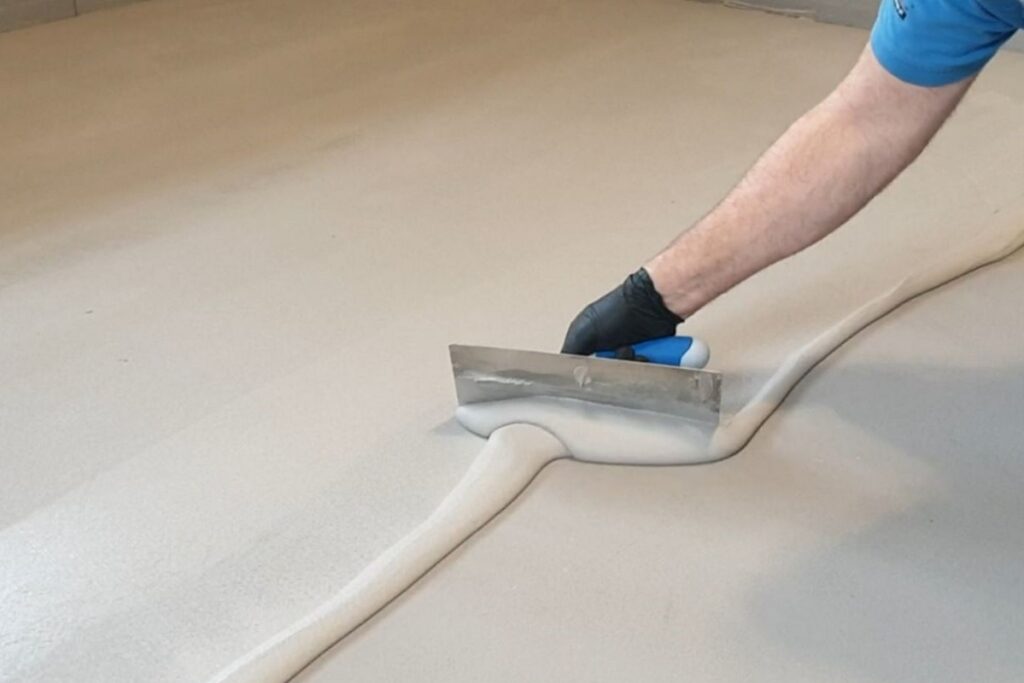 Nakładanie mikrocementu FINO FAST pacą na przygotowaną powierzchnię w trakcie aplikacji. Cienka warstwa materiału tworzy bardzo gładkie wykończenie charakterystyczne dla mikrocement&oacute;w FAST.